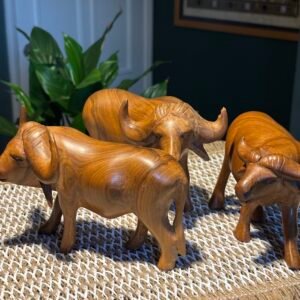 A lovely vintage hand carved herd of teak wooden water buffalos, Folk Art animal sculpture x 3.