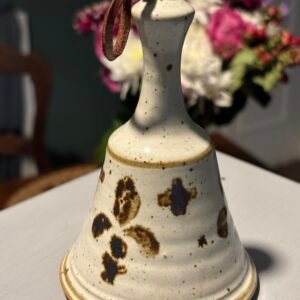 Vintage studio art pottery bell with a brown speckled design.
