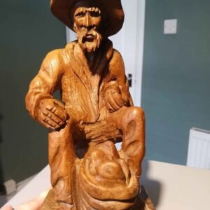 Vintage carved folk art, wooden sculpture of a traveller, tramp.